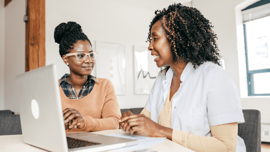 Two women doing a healthcare seo search on their laptop. 