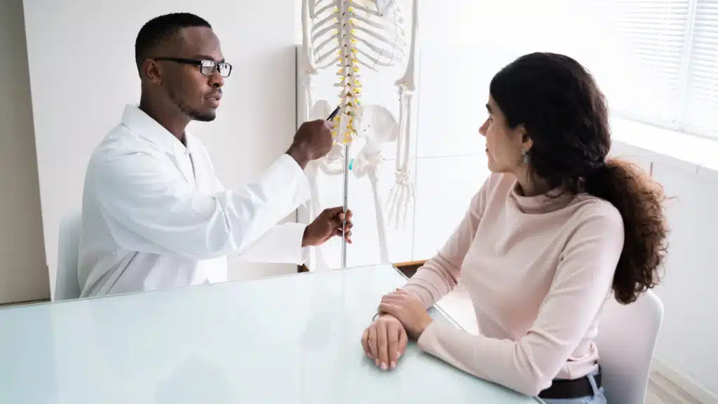 Chiropractor talking with patient