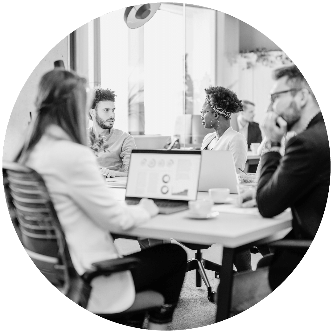 Meeting In a conference room with a computer showing a report.