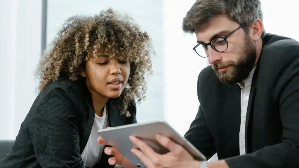 Two people looking at an iPad.