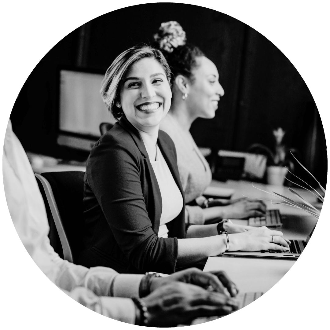 Woman smiling at a marketing agency meeting.