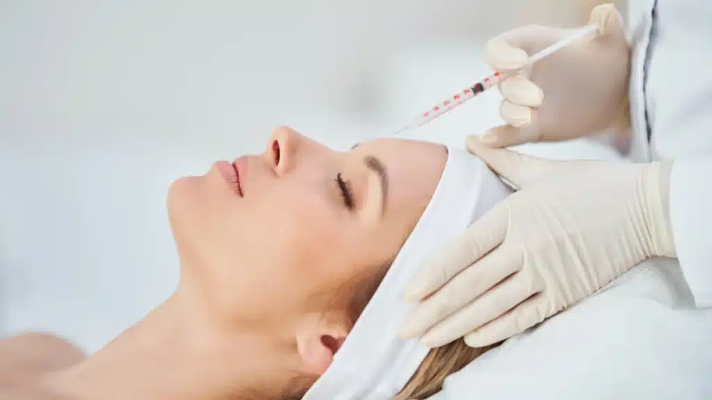 Woman receiving Botox in her forehead at a luxury healthcare spa, representing premium services. Ideal for content related to Google Maps advertising, PPC consultant strategies, and how to increase leads from Google through optimized local business listings.