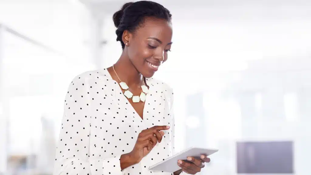 Professional businesswoman using a tablet in her office, symbolizing digital strategy and planning for marketing for dental practices.